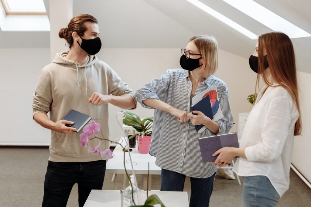 3 people wearing face masks at work