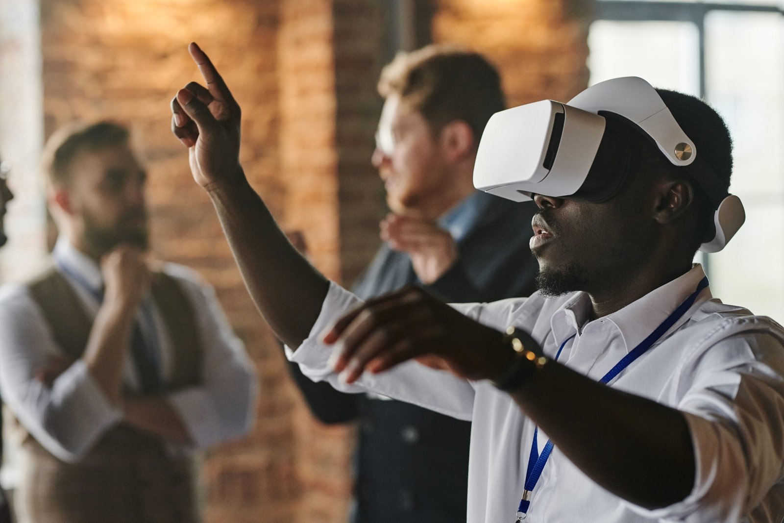 Man wearing virtual reality glasses in a room with people